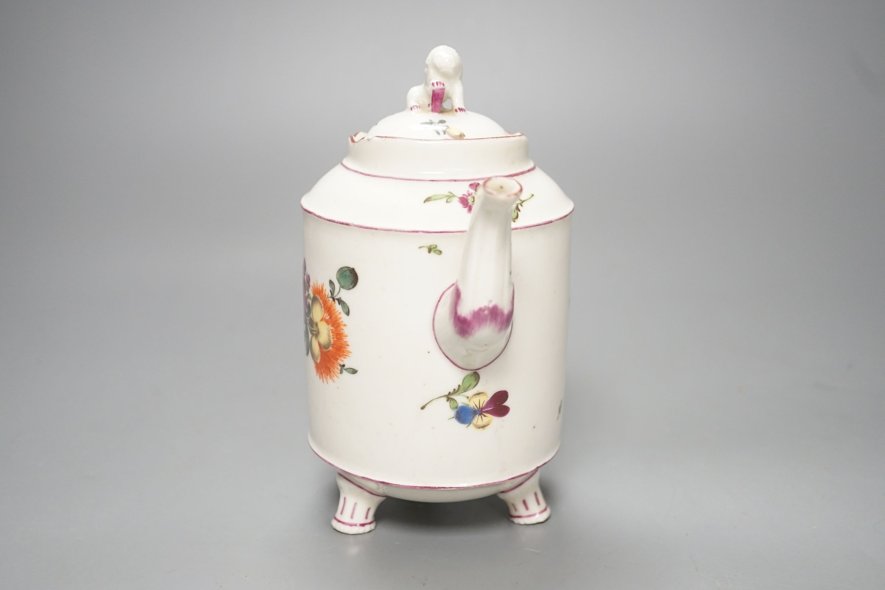 An 18th century Ludwigsburg three footed teapot and cover with lion finial and lion head on handle painted with flowers, height overall 16.5cm